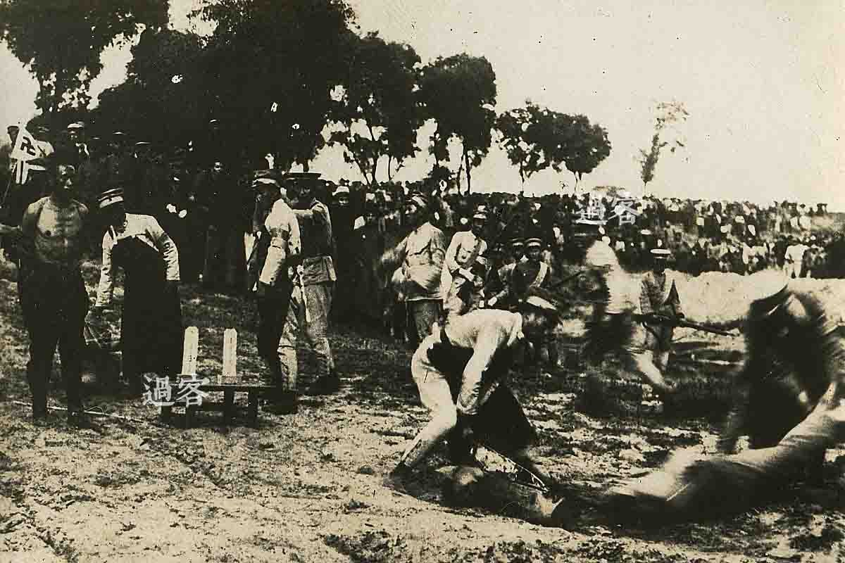 这是第三张照片，有种说法是铡刀很钝，所以特别疼，时间也比斩首要长。在不远处围观的人群里，可以清晰地看到几个身着昭和五年制式军服（简称昭五式军服）的日本军人。昭五式军服系日军1930年至1938年期间日军的制式军服，其特点是竖式肩章与立式衣领，1938年5月开始逐渐被新式的九八式军服所取代。（来源：网易新媒体）